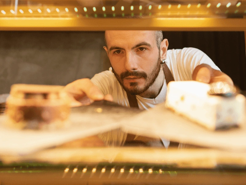 kitchen worker peering through counter