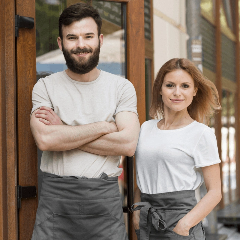 Shop owners standing outside the front door