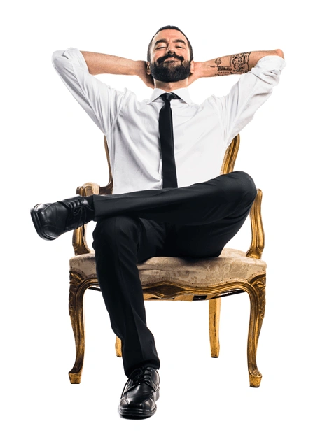 Man sitting in a chair with his hands behind his head