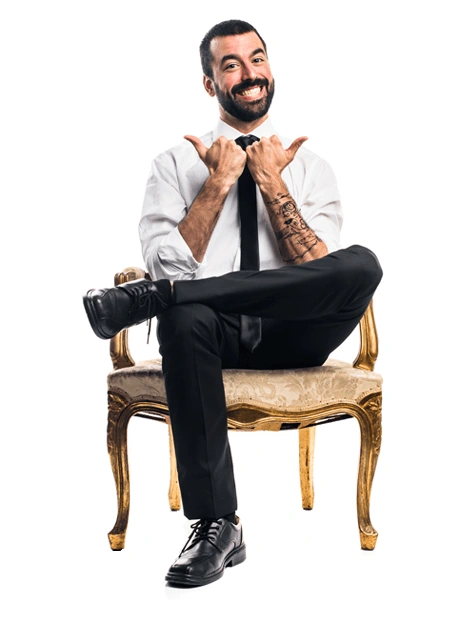 Man sitting in a chair giving the double thumbs up