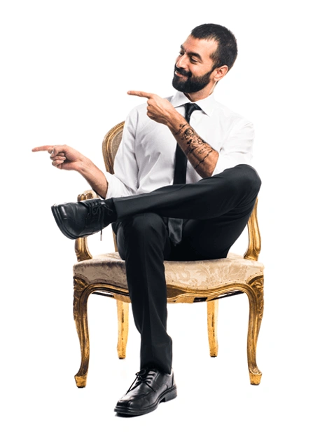 Man sitting in a chair pointing to the left